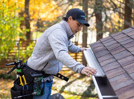 gutter contractor in wisconsin installing gutter guards